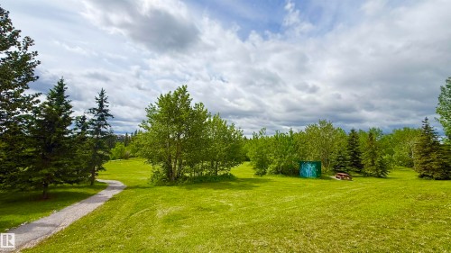 Expansive green space featuring mature trees and a winding paved pathway - 9 225 Blackburn Drive E, Edmonton, AB 