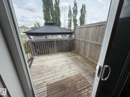 Outdoor deck featuring wood planking and a gazebo with a dark metal roof - 6821 Evans Wynd, Edmonton, AB 