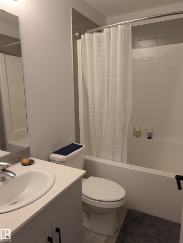 Bathroom featuring a built-in tub and shower combination with a tiled surround - 9240 224 Street Nw, Edmonton, AB - Indoor Photo Showing Bathroom