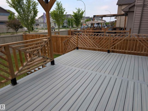 Spacious multi-level deck featuring composite decking and custom wood railing designs - 9240 224 Street Nw, Edmonton, AB - Outdoor With Deck Patio Veranda With Exterior