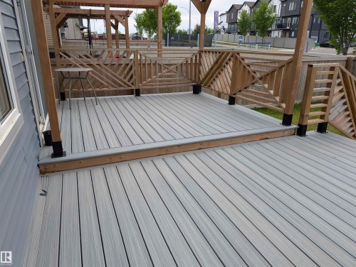 Multi-level outdoor deck featuring composite decking, natural wood railings, and a pergola structure - 9240 224 Street Nw, Edmonton, AB - Outdoor With Deck Patio Veranda With Exterior