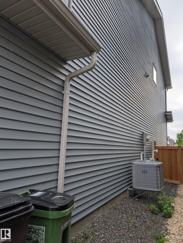 Gray horizontal vinyl siding with white soffit and gutter system - 9240 224 Street Nw, Edmonton, AB - Outdoor