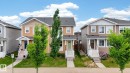 Contemporary two-story residence featuring light orange siding and a dark shingle roof - 165 Robinson Drive, Leduc, AB 
