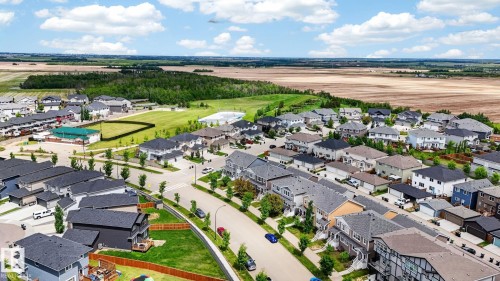 Aerial perspective showcasing a residential community with varied architectural styles - 165 Robinson Drive, Leduc, AB 