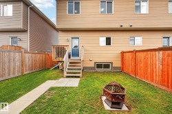 Private backyard featuring a manicured lawn and perimeter fencing - 
