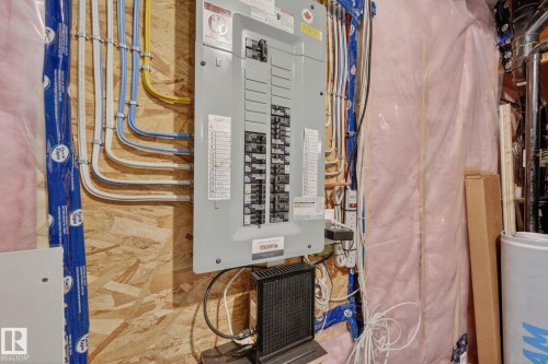 Electrical panel mounted on an OSB wall - 165 Robinson Drive, Leduc, AB 