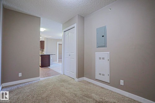 Carpeted room with neutral wall color and white trim - 405 11804 22 Avenue Sw, Edmonton, AB 