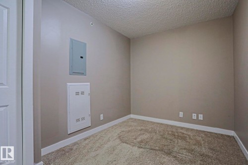 Neutral-toned walls complement the textured ceiling - 405 11804 22 Avenue Sw, Edmonton, AB 