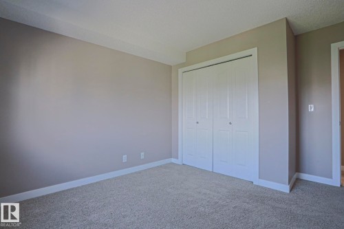 Neutral-toned wall paint and matching carpet flooring - 405 11804 22 Avenue Sw, Edmonton, AB 