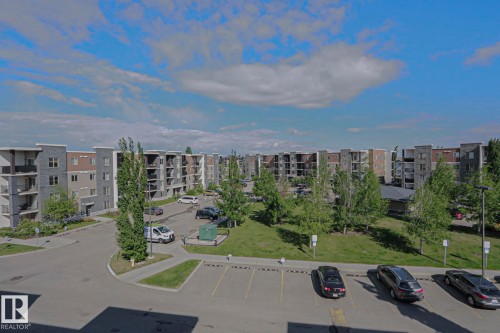 Contemporary multi-story apartment buildings featuring private balconies and varied facade materials - 405 11804 22 Avenue Sw, Edmonton, AB 