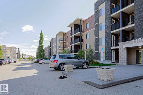 Modern multi-story building featuring stacked stone and siding facade - 405 11804 22 Avenue Sw, Edmonton, AB 
