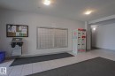 Building entrance featuring mailboxes, parcel lockers, and a bulletin board - 405 11804 22 Avenue Sw, Edmonton, AB 