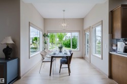 Dining area with wood-finish flooring and neutral wall tones - 