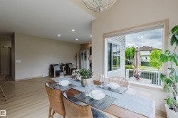 Dining area featuring wood-finish flooring and recessed lighting - 