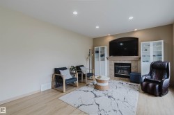 Living area featuring wood-finish flooring, recessed lighting, and a neutral color palette - 
