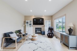 Living area featuring light wood-finish flooring and recessed ceiling lighting - 
