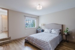 Spacious room with wood-finish flooring and a light neutral color palette - 