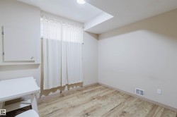 Room featuring wood-finish flooring, neutral wall tones, and a window with blinds - 
