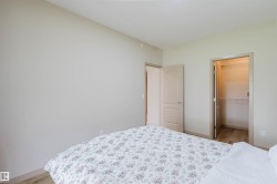 Interior room featuring light-colored walls and wood-finish flooring - 