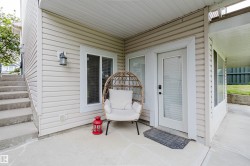 Covered concrete patio with horizontal siding facade - 