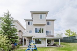 Multi-level exterior with light-colored siding - 