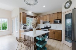 Light wood-finish flooring complements the warm-toned cabinetry in this kitchen - 