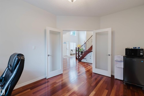 Room featuring wood-finish flooring, white painted walls, and a ceiling-mounted light fixture - 20524 58 Avenue, Edmonton, AB 