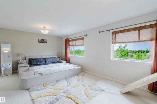Bedroom with neutral wall tones and light-colored carpeting - 20524 58 Avenue, Edmonton, AB 