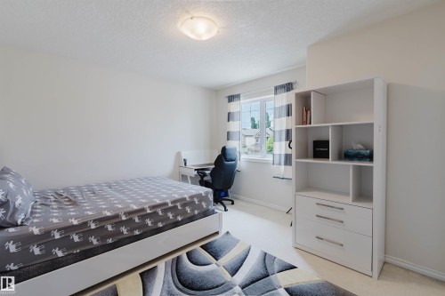 Bedroom featuring light-toned walls, white trim, and a ceiling-mounted flush light fixture - 20524 58 Avenue, Edmonton, AB 