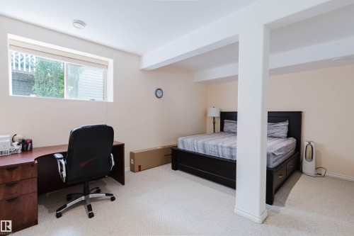 Versatile room featuring light-colored carpeting, a window, and recessed lighting - 20524 58 Avenue, Edmonton, AB 