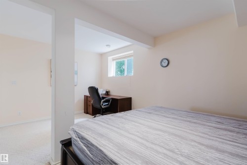 Carpeted room featuring a white ceiling, a single window, and neutral-toned walls - 20524 58 Avenue, Edmonton, AB 