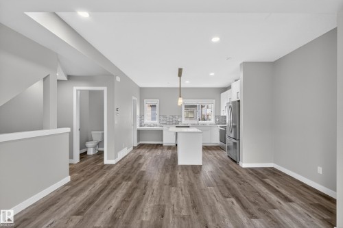 Open-concept living area featuring wood-finish flooring, recessed lighting, and a neutral color palette - 90 1010 Rabbitt Hill Road Sw, Edmonton, AB - Indoor