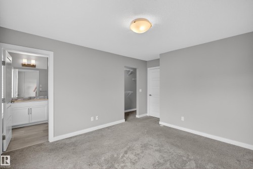 Bedroom featuring gray carpeting, light gray wall paint, and a semi-flush mount ceiling light - 90 1010 Rabbitt Hill Road Sw, Edmonton, AB - Indoor Photo Showing Other Room