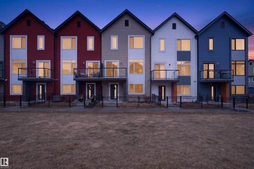 Modern townhome exteriors featuring gabled roofs and multi-colored siding - 90 1010 Rabbitt Hill Road Sw, Edmonton, AB - Outdoor With Balcony