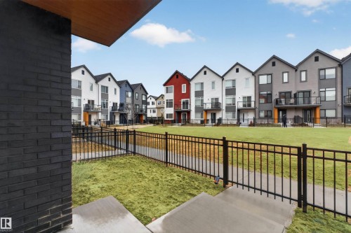 Modern townhome architecture featuring varied exterior finishes including brick and siding - 90 1010 Rabbitt Hill Road Sw, Edmonton, AB - Outdoor With Balcony