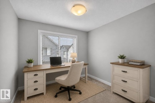 Carpeted room with light gray walls and a single window featuring horizontal blinds - 90 1010 Rabbitt Hill Road Sw, Edmonton, AB - Indoor Photo Showing Office