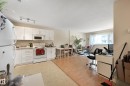 Kitchen featuring white cabinetry with brushed nickel hardware, white appliances, and a light-toned countertop - 901 9710 105 Street, Edmonton, AB  - Indoor Photo Showing Kitchen 