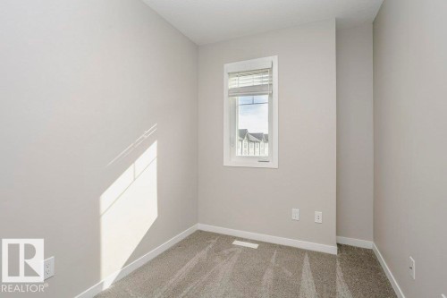 Room with light grey walls, white trim, and grey carpet - 320 Secord Boulevard, Edmonton, AB - Indoor Photo Showing Other Room