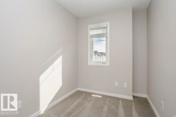 Room with light grey walls, white trim, and grey carpet - 