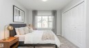 Bedroom featuring light gray walls, wood-finish flooring, a contemporary window with drapes, and white bi-fold closet doors - 320 Secord Boulevard, Edmonton, AB  - Indoor Photo Showing Bedroom 