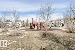 The property is situated within a community featuring a park with a playground structure and surrounding residential buildings - 