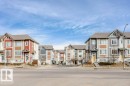 This property features a contemporary architectural style with varied exterior finishes including siding and stone accents - 320 Secord Boulevard, Edmonton, AB  - Outdoor With Facade 