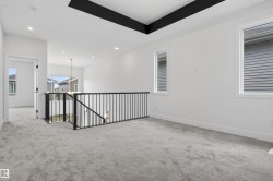 Bright interior space with light-toned carpeting and white walls - 