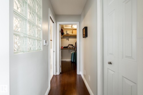 Hallway featuring rich wood-finish flooring and a glass block wall - 2036 Towne Centre Boulevard, Edmonton, AB - Indoor Photo Showing Other Room