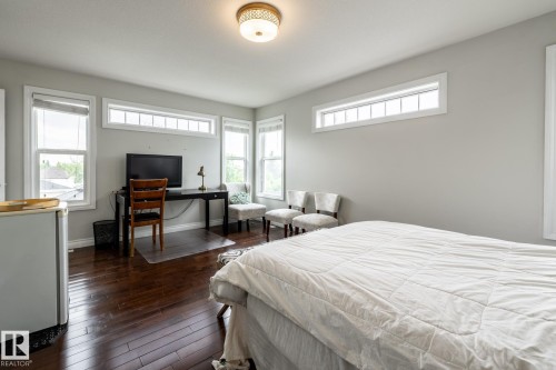 Spacious room featuring rich wood-finish flooring and light grey walls - 2036 Towne Centre Boulevard, Edmonton, AB - Indoor Photo Showing Bedroom