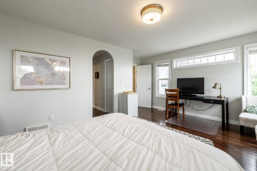 Hardwood-finish flooring enhancing a light-filled room with multiple windows, including a transom window - 2036 Towne Centre Boulevard, Edmonton, AB - Indoor Photo Showing Bedroom