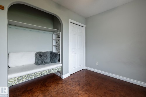 Arch-top wall niche featuring a built-in daybed with upholstered cushions and integrated shelving - 2036 Towne Centre Boulevard, Edmonton, AB - Indoor Photo Showing Other Room