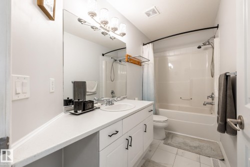 Bathroom featuring a white vanity with integrated sink, chrome faucet, and spacious countertop - 2036 Towne Centre Boulevard, Edmonton, AB - Indoor Photo Showing Bathroom