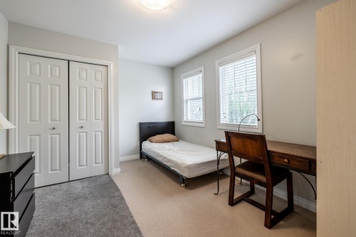 Light-filled room featuring two windows with white blinds, a neutral wall color, white baseboards, and a combination of light and dark carpeting - 2036 Towne Centre Boulevard, Edmonton, AB - Indoor Photo Showing Bedroom