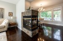 Stone-clad fireplace with a two-sided glass enclosure - 2036 Towne Centre Boulevard, Edmonton, AB  - Indoor Photo Showing Other Room With Fireplace 